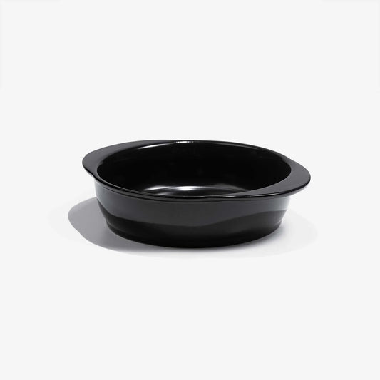 A professional black Xtrema pure ceramic baking dish on a white background.