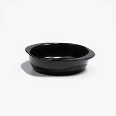 A professional black Xtrema pure ceramic baking dish on a white background.