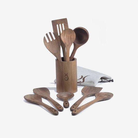 Xtrema professional wooden kitchen utensil set in a matching holder with a gray cloth.