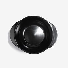Top-down view of a black Xtrema pure ceramic cookware pot with handles.
