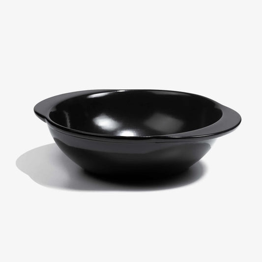 A professional black Xtrema pure ceramic baking dish on a white background.