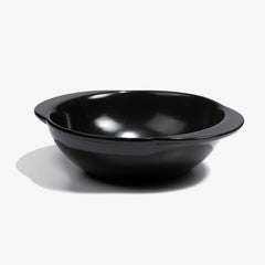 A professional black Xtrema pure ceramic baking dish on a white background.