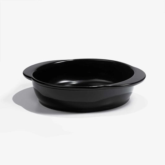 A professional black Xtrema pure ceramic baking dish on a white background.