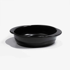 A professional black Xtrema pure ceramic baking dish on a white background.