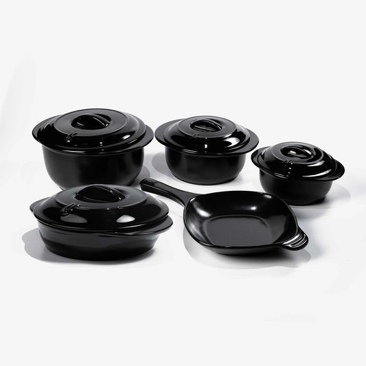 Set of black Xtrema pure ceramic cookware including pots with lids and a frying pan.