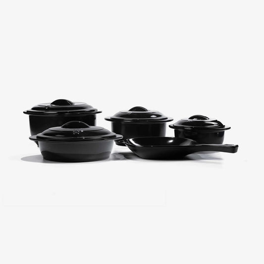 Set of black Xtrema pure ceramic cookware including pots with lids and a skillet.