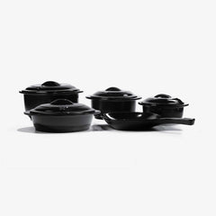 Set of black Xtrema pure ceramic cookware including pots with lids and a skillet.