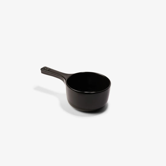 Xtrema black pure ceramic measuring cup on a white background.