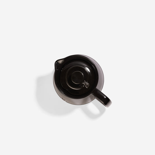 Top-down view of a sleek black Xtrema pure ceramic pitcher with lid.