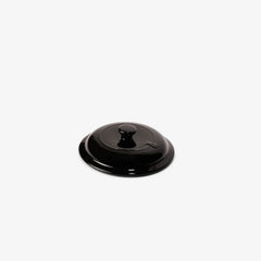 Xtrema black ceramic cookware lid with a central knob on a white background
