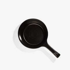 Top view of a black Xtrema pure ceramic frying pan on a white background.