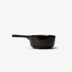 Professional black Xtrema pure ceramic saucepan with handle on a white background