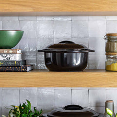 Professional Xtrema black ceramic pot with lid on a wooden kitchen shelf.