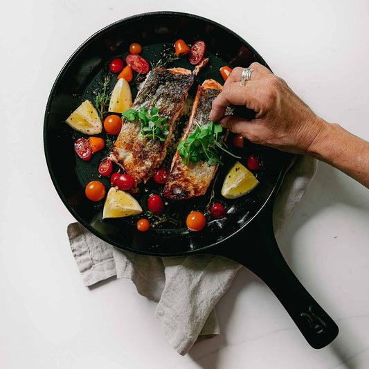 Pan-seared salmon with tomatoes and lemon in an Xtrema ceramic skillet.