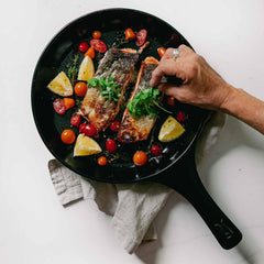 Pan-seared salmon with tomatoes and lemon in an Xtrema ceramic skillet.