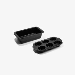 Xtrema black ceramic loaf pan and six-cup muffin tray on a white background.