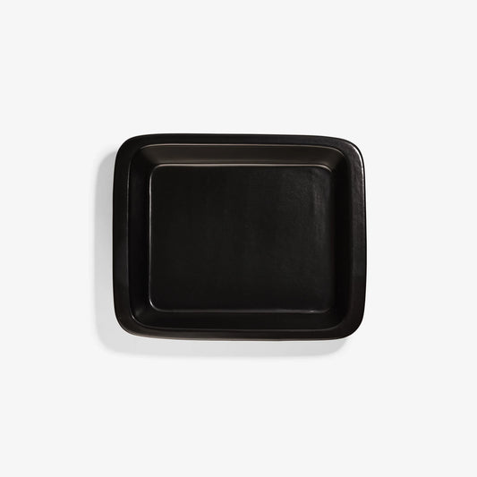 Top view of a rectangular black Xtrema pure ceramic baking dish on a white background.