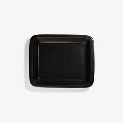 Top view of a rectangular black Xtrema pure ceramic baking dish on a white background.