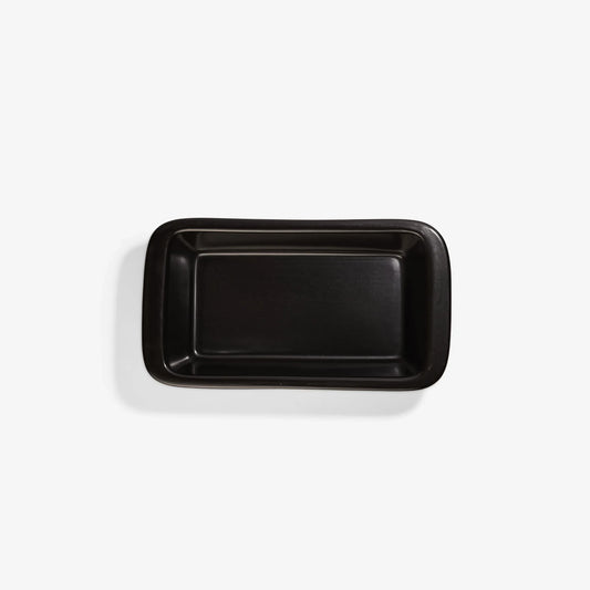 Top view of a black Xtrema pure ceramic rectangular baking dish on a white background.