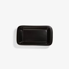 Top view of a black Xtrema pure ceramic rectangular baking dish on a white background.