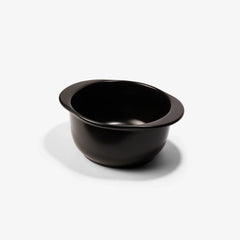 A sleek black Xtrema pure ceramic mixing bowl with a pouring lip on a white background.
