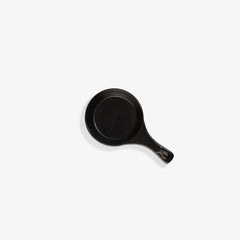 Top-down view of a sleek black Xtrema pure ceramic frying pan on a white background.