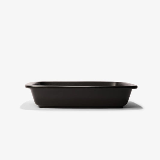 Professional black Xtrema pure ceramic rectangular baking dish on a white background.