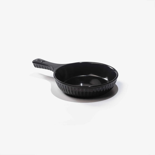 Xtrema black pure ceramic skillet with ribbed exterior on a white background