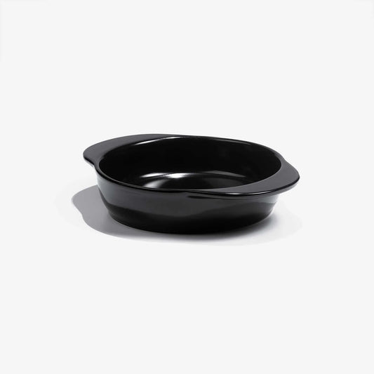 A sleek black Xtrema pure ceramic baking dish with integrated handles on a white background.