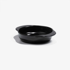 A sleek black Xtrema pure ceramic baking dish with integrated handles on a white background.
