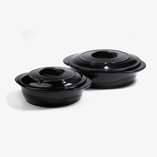 Two glossy black Xtrema pure ceramic cookware pots with lids on a white background.
