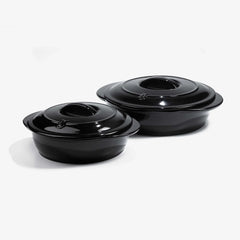 Two glossy black Xtrema pure ceramic cookware pots with lids on a white background.