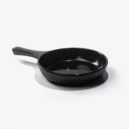Professional black Xtrema pure ceramic skillet with a ribbed exterior and handle.