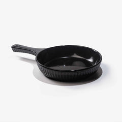 Professional black Xtrema pure ceramic skillet with a ribbed exterior and handle.
