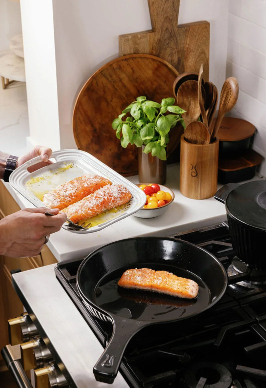 Searing salmon fillets in an Xtrema ceramic skillet on a gas stovetop.