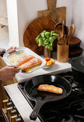 Searing salmon fillets in an Xtrema ceramic skillet on a gas stovetop.