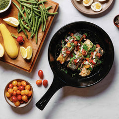 Pan-seared fish with fresh salsa in a black Xtrema ceramic skillet with healthy sides.