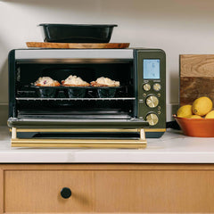 Xtrema ceramic ramekins with baked treats inside a modern countertop oven.