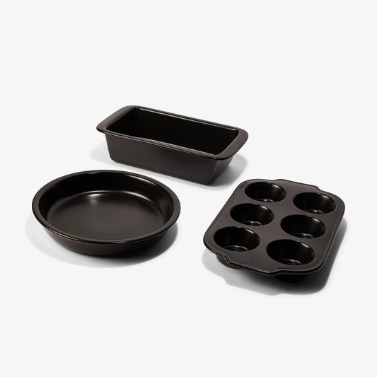 Xtrema black ceramic bakeware set featuring a loaf pan, pie dish, and muffin pan.