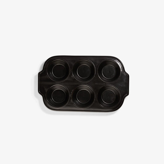 Xtrema black ceramic muffin pan with six circular cups on a white background