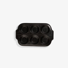 Xtrema black ceramic muffin pan with six circular cups on a white background