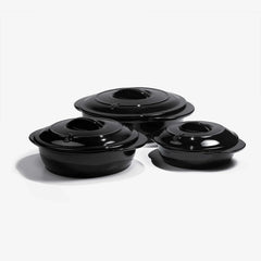 Set of three black Xtrema pure ceramic cookware pots with lids on a white background.