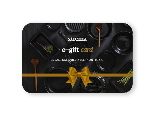 Xtrema e-gift card featuring professional black ceramic cookware with a gold ribbon bow.