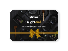 Xtrema e-gift card featuring professional black ceramic cookware with a gold ribbon bow.