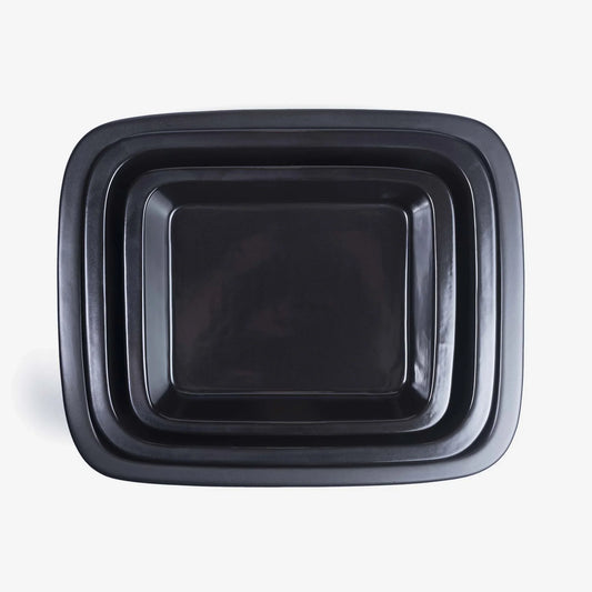 Set of nested Xtrema black pure ceramic roasting pans viewed from above.