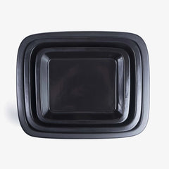 Set of nested Xtrema black pure ceramic roasting pans viewed from above.